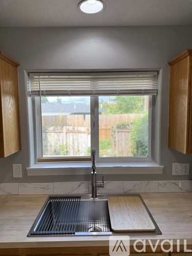 A kitchen with a sink and a window.