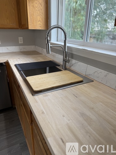 A kitchen with a sink and a window.