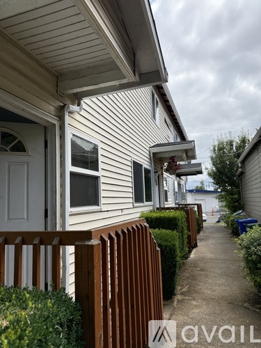 A row of houses with a wooden fence in front.