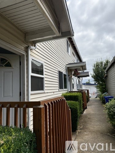 A row of houses with a wooden fence in front.