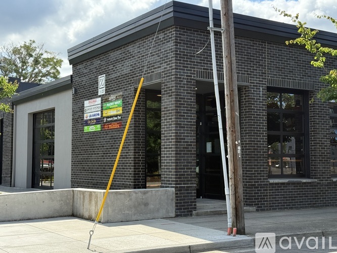 A brick building with a sign that says "AVAILABLE" in the foreground.