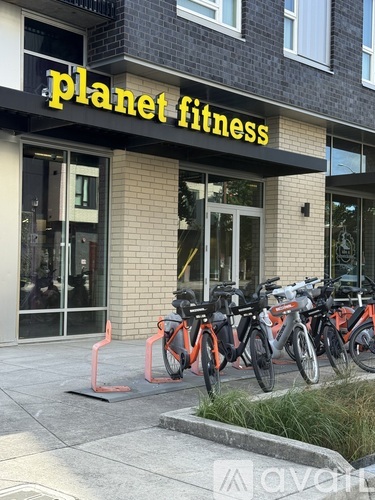 A gym named Planet Fitness with bikes parked outside.