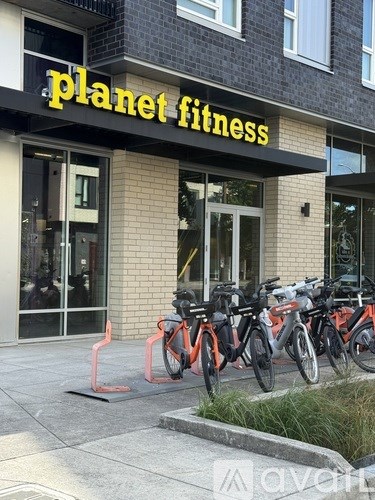 A gym named Planet Fitness with bikes parked outside.