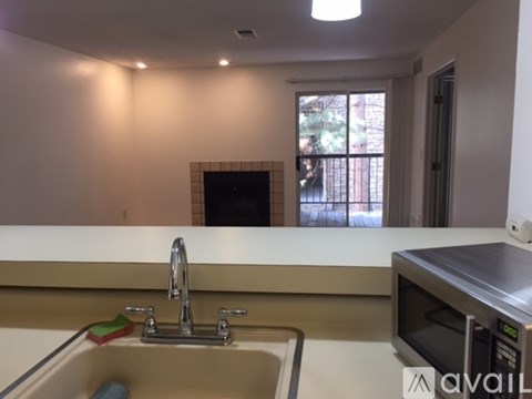 A kitchen with a sink and a microwave.