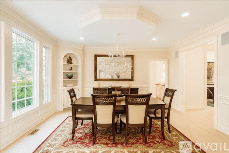 A dining room with a table set for six.