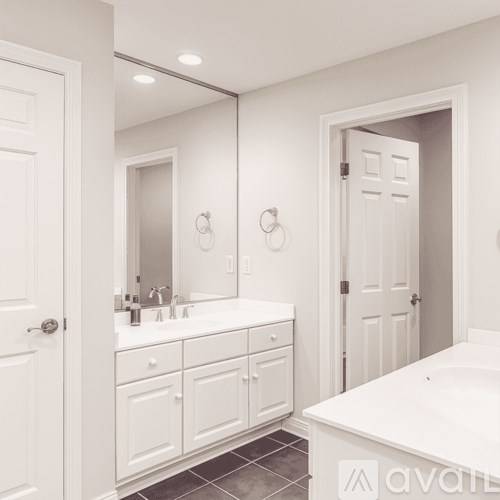 A bathroom with a white tub and sink.