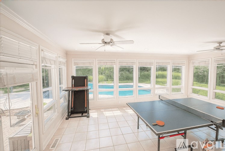 A room with a pool table and a television.