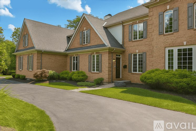 A large house with a driveway in front of it.