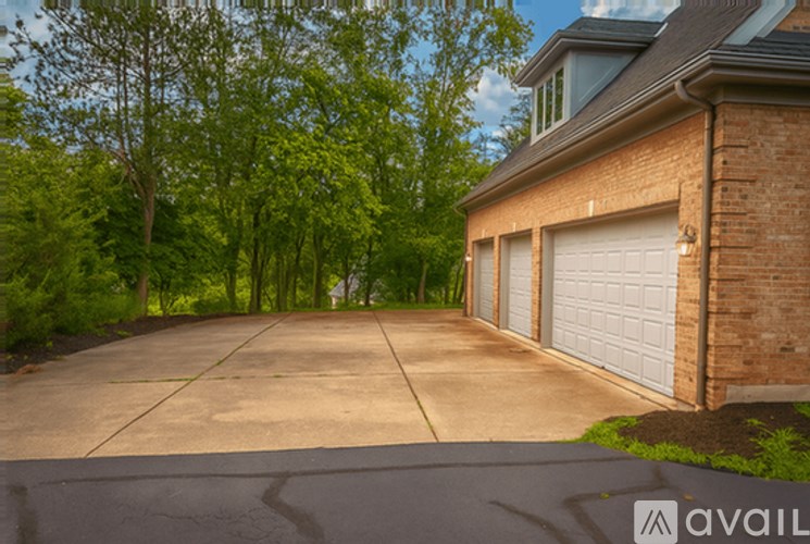 A house with a driveway and garage doors.