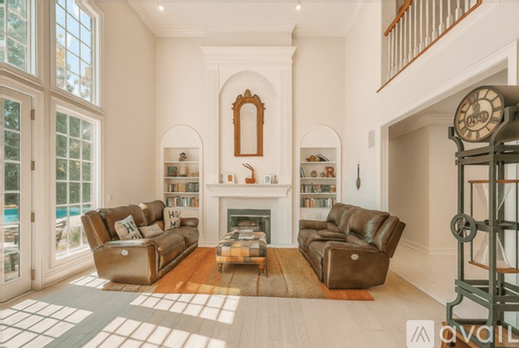 A living room with a fireplace, two couches, and a rug.