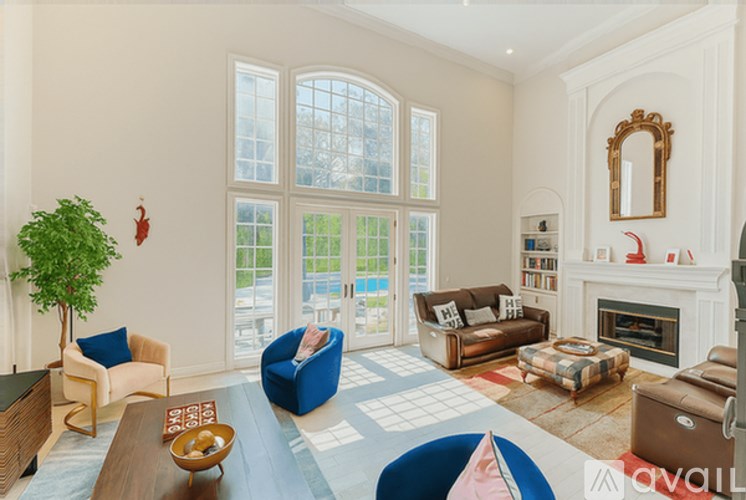 A living room with a fireplace and a large window.