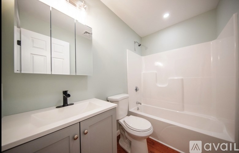 A white toilet sits next to a sink in a bathroom.