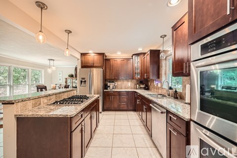 A kitchen with brown cabinets and stainless steel appliances.
