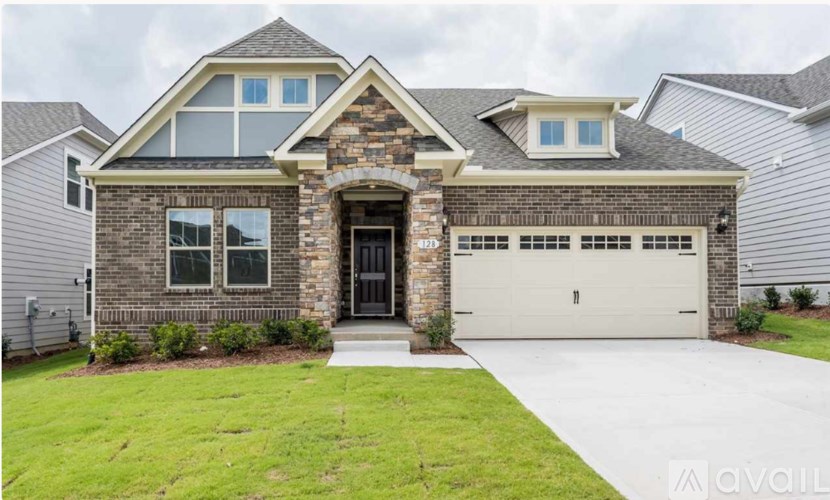 A house with a stone facade and a large garage door.
