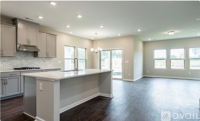 A spacious kitchen with a large island in the middle.