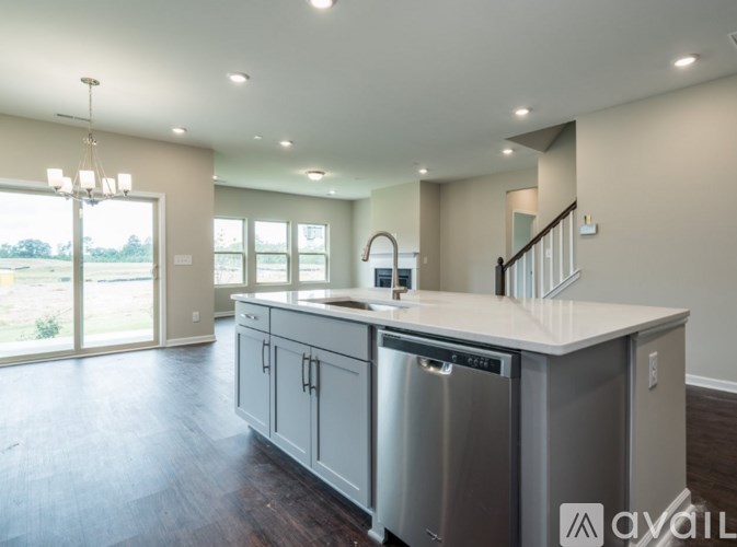 A modern kitchen with stainless steel appliances and a large island.