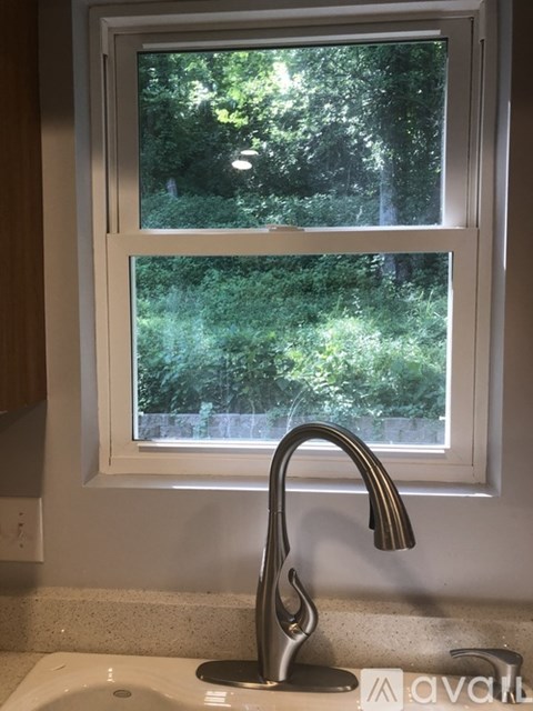 A kitchen sink with a window above it.