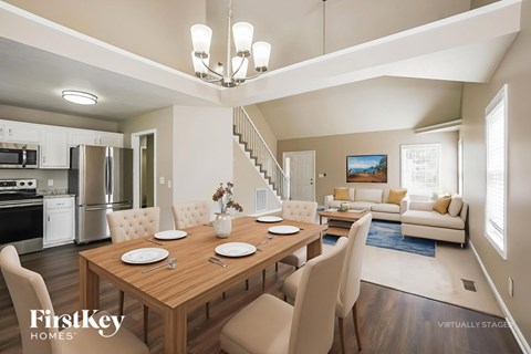 A dining room with a wooden table set for four.