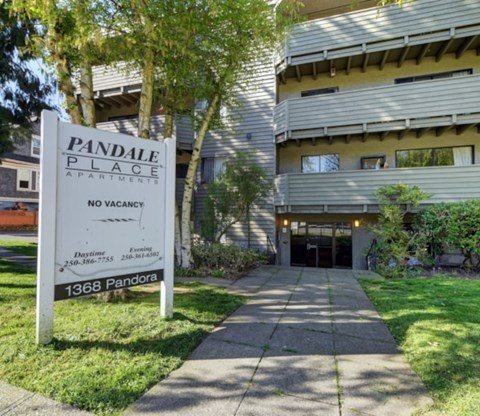 A sign in front of a building that says Pandale Place with no vacancy.