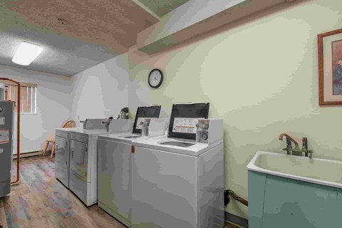 A bathroom with a sink, mirror, and cabinets.