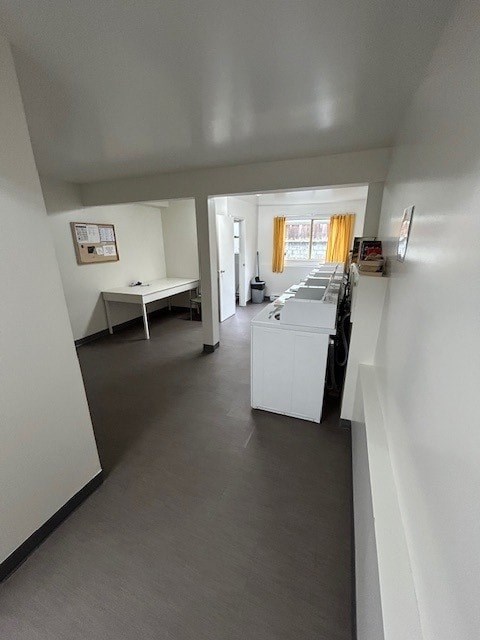 A white kitchen with a table and chairs.