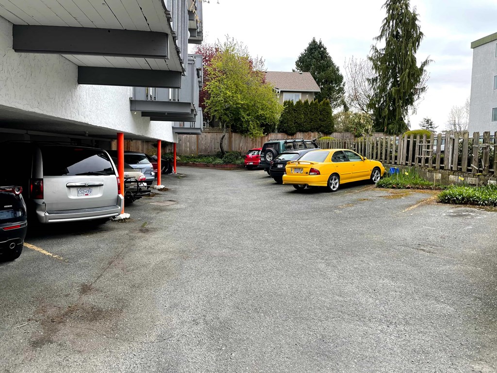 A yellow car is parked in a parking lot.