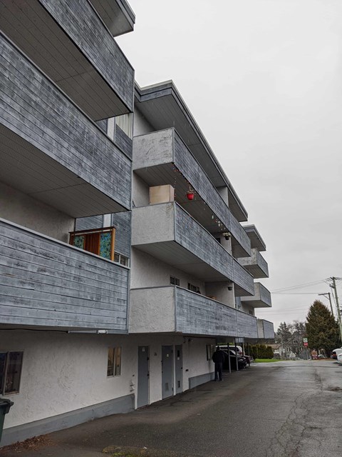 A grey building with a red light on.