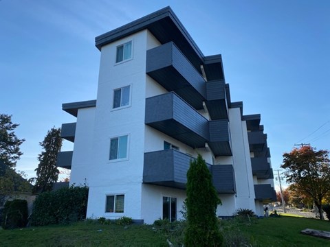 A modern white and black building with balconies.