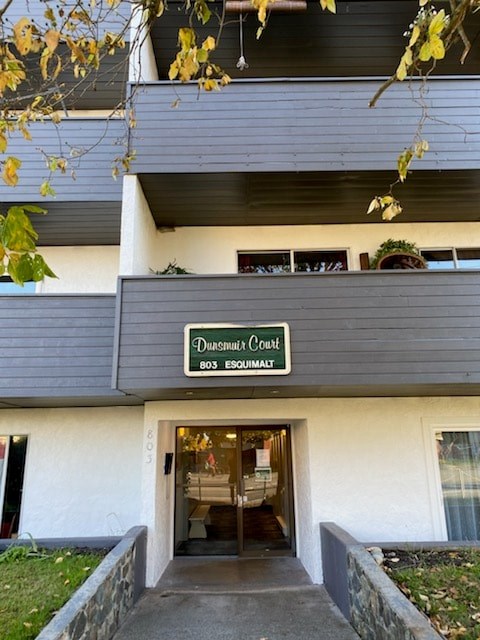 The entrance to a building with a sign that reads Dunseith Court.