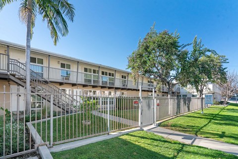 A sunny day at a residential complex with a clear blue sky.