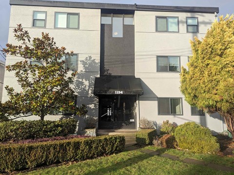 A modern building with a black awning and the number 1194 on it.