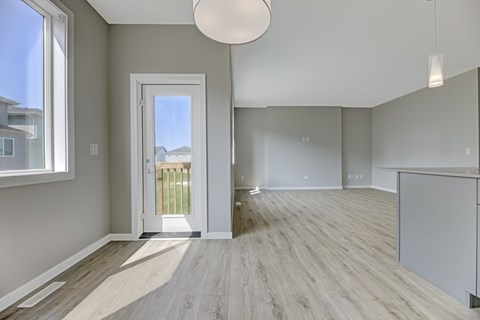 A room with a wooden floor and a white ceiling with a light fixture.