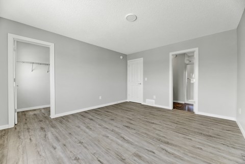 A room with a wooden floor and white walls.