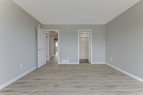 A long, empty hallway with doors on both sides.