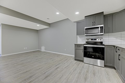 A kitchen with a stove top oven and microwave.