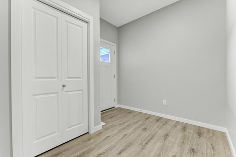 A white door is on the left and a window is on the right.