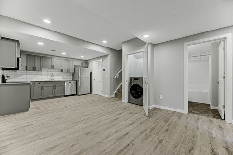 A spacious kitchen with a dining area and a staircase.