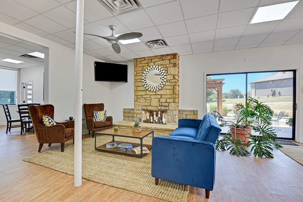 A living room with a fireplace and a flat screen TV.