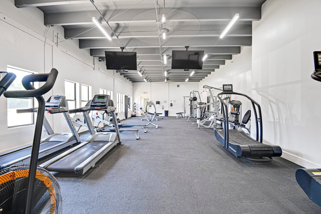 A gym with treadmills and exercise bikes.