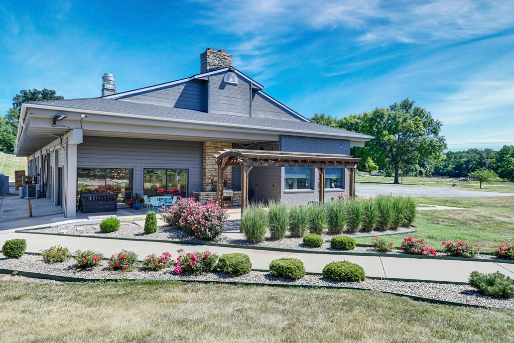 A house with a grey roof and a blue sky in the background.