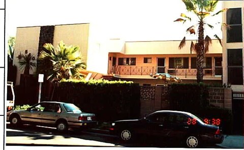 A black car is parked on the side of the road.