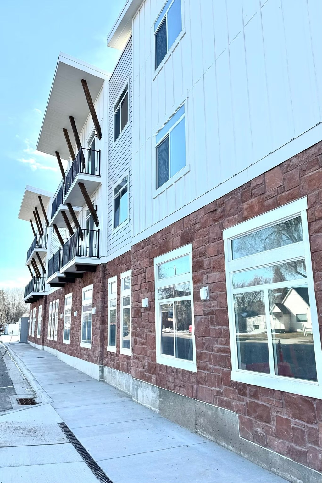 A row of houses with balconies and windows.