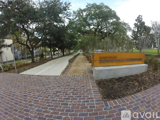 A brick pathway leads to a sign that says Bowntown Greenway.