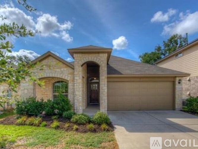 A house with a brown garage door and a stone facade.