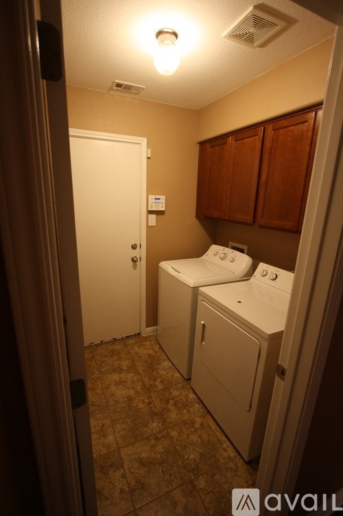 A small bathroom with a toilet, sink and mirror.