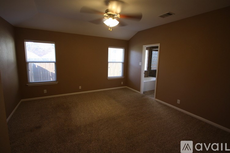 A room with brown walls and a ceiling fan.