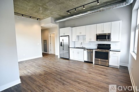 A kitchen with white cabinets and stainless steel appliances.