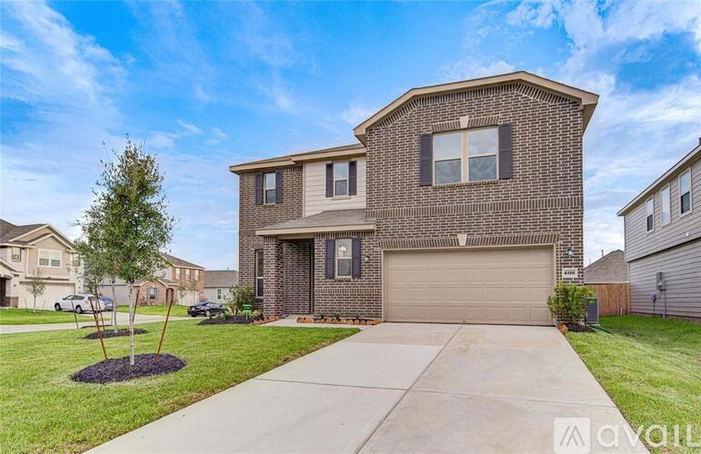 A two-story house with a garage is for sale.