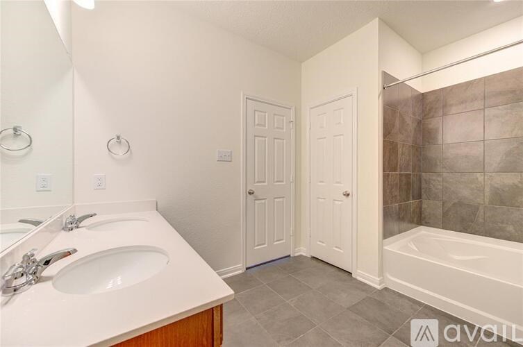 A bathroom with a white sink and a white tub.