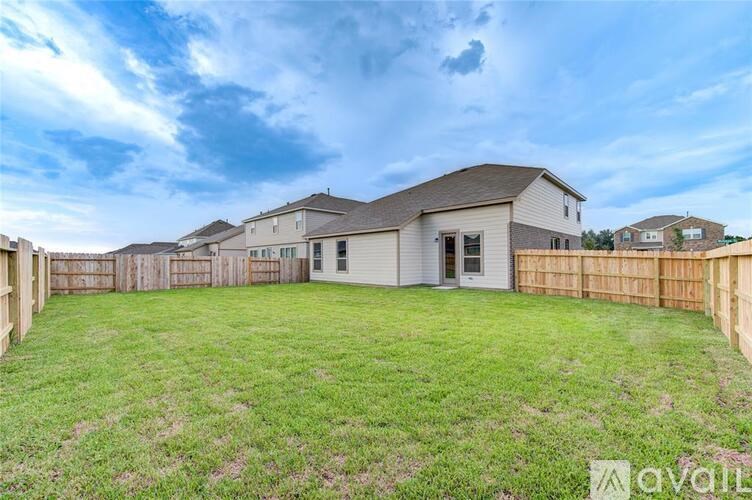 A house with a fenced backyard is for sale.